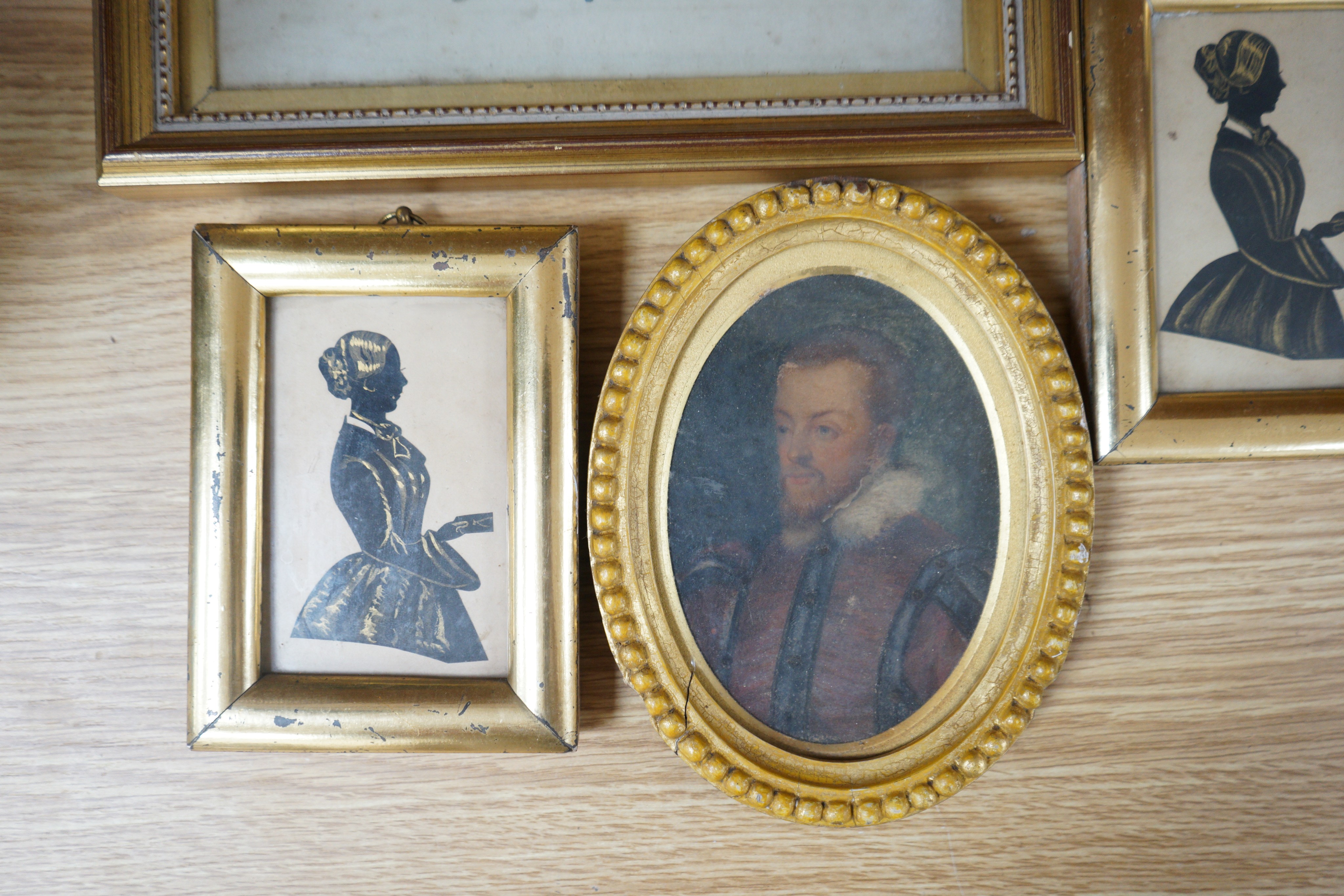 Victorian School, two bronzed cut paper silhouettes of Miss Rogers, Granny Hopegood's nurse 1854, 10 x 6cm, two other miniatures, a small watercolour of a Country House called Blickling, 18 x 13cm and an illuminated Arms